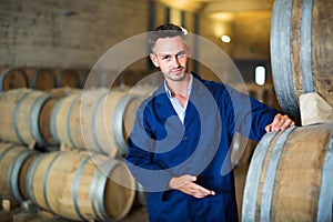 Man working on secondary fermentation equipment in winery manufactory