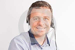 man working smiling with headset in call center