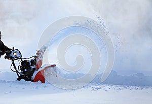 Man working with snow blower