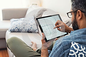 Man working on tablet on house project