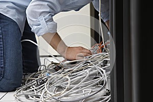 Man Working On Tangled Computer Wires