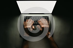 Man is working typing use laptop computer at dark
