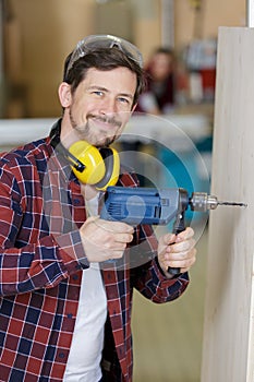 man working using electric drill