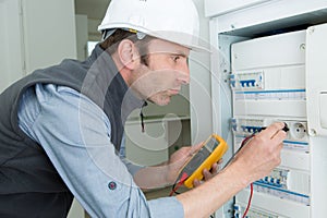 man working using multimeter electrician concept