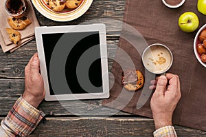 Man working with using a tablet computer in the morning