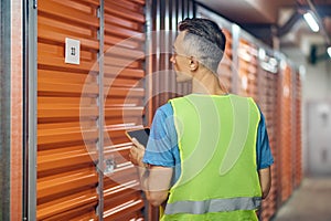 Man working in warehouse guard standing with back