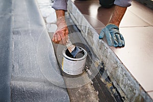 Man working with waterproofing material