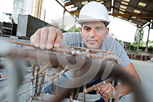 Man working with wire for reinforced stell