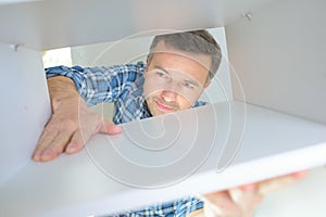 Man working on wood shaper in carpenter workshop