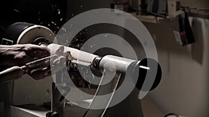 Man working on woodworking lathe machine in carpenter workshop. Close up