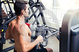 Man workout on fitness machine at gym
