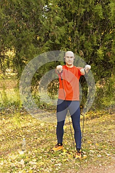 Man workout in park, autumn background