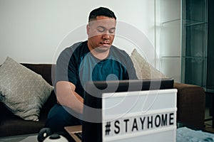 Man works from home to avoid harming other people`s dangers. hashtag stay home