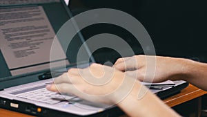 Man Works for Laptop Keyboard on Wooden Desk