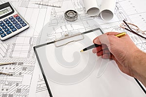 Man works with the technical drawing