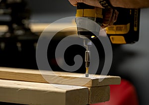 a man works with wood panels and tools in his workshop. real life.