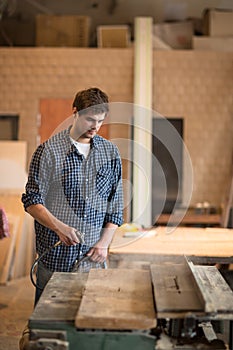 Man in workshop, carpentry workshop tidying, dusting pneumatic