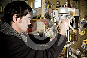 Man in workshop using drill