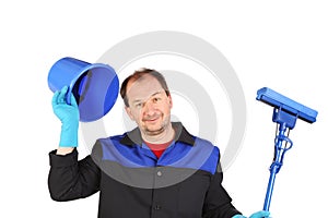Man in workwear with bucket and mop.