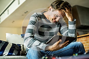 Man with worried emotion using tablet