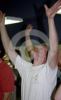 Man worships God with hands raised during a church servive