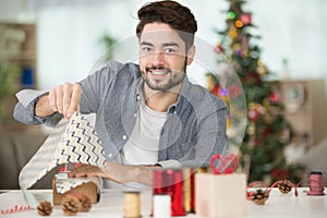 man wrapping christmas present