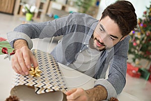 Man wrapping christmas presents
