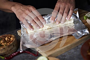 Man wrapping a durum or a burrito