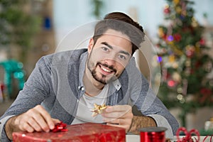 man wrapping gift