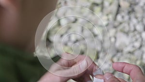 A man wraps his fingers on his hand with a Band-Aid