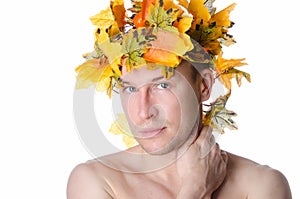 Man in a wreath of maple leaves. Autumn mood. White background