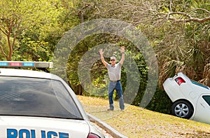 Man wrecked car into deep ditch waving down police officer car photo