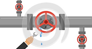 A man with a wrench eliminates the leak in the pipe. The hand holds a wrench and eliminates leakage in the water pipe.