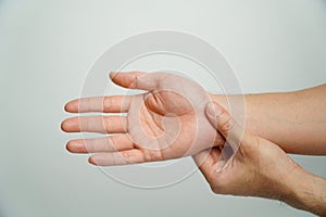 Man with wrist pain from using computer on white background, health care and medical concept,Office syndrome hand pain by