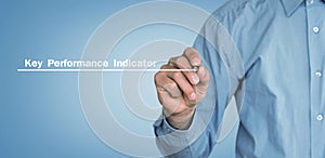Man writes Key Performance Indicator text on screen.