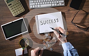 Man writes text Success in notepad