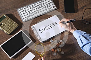 Man writes text Success in notepad