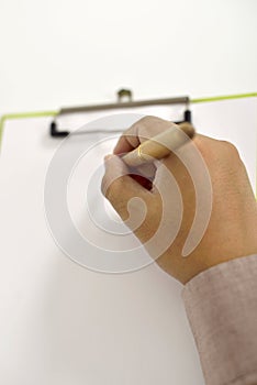 Man Writing On Blank Paper On Clipboard