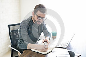 Man writing book at home