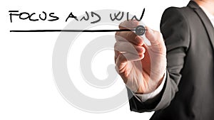 Man writing a business motivational message Focus and win