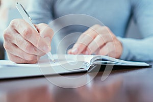 Man writing day planner work schedule organizer