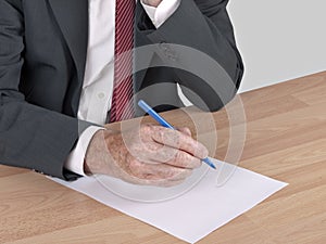 Man writing at desk - resignation