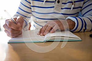 Man writing in a diary photo