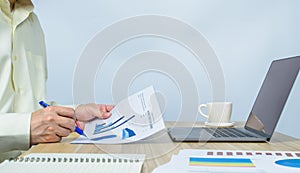 man writing on document data graph on working desk with copy space