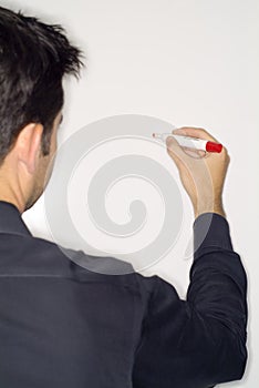 Man writing on dry erase board photo