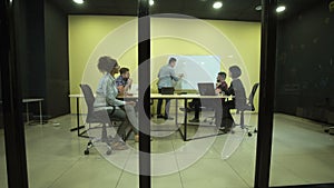 Man writing on flipchart at business meeting