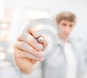 Man writing on glass board or working with virtual screen