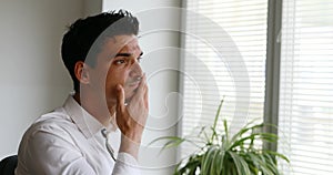 Man writing at his laptop, then stopping and restarting