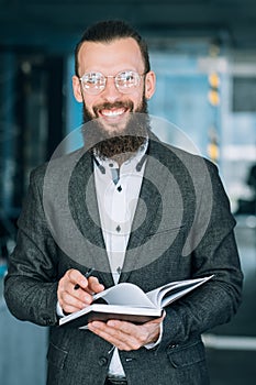 Man writing info notebook records data analysis