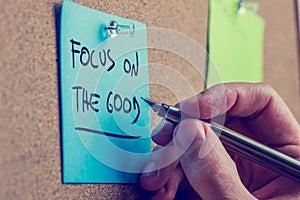 Man writing a motivational message on a board